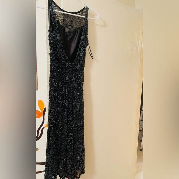 A gorgeous mid length beaded dress by Scala. - Picture 1 of 11